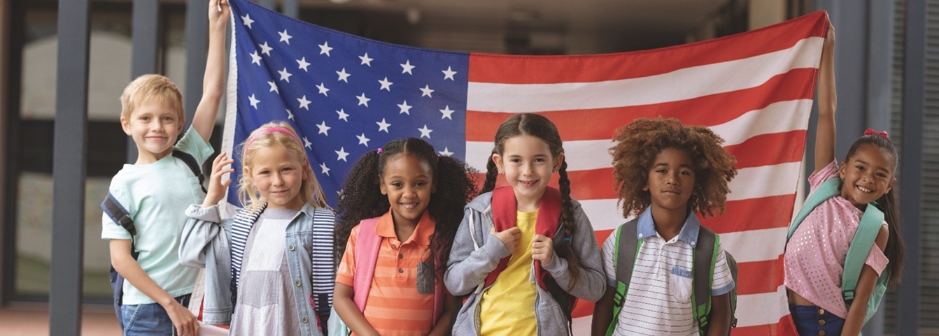 diverse children with the American flag behind them